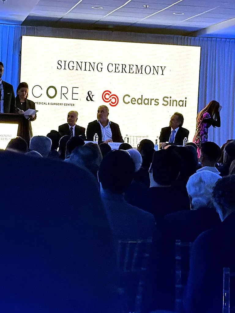 Andrew Hillman. Signing ceremony of CORE hospital with Cedars Sinai. Backdrop text: SIGNING CEREMONY, CORE Medical & Surgery Center & Cedars Sinai.