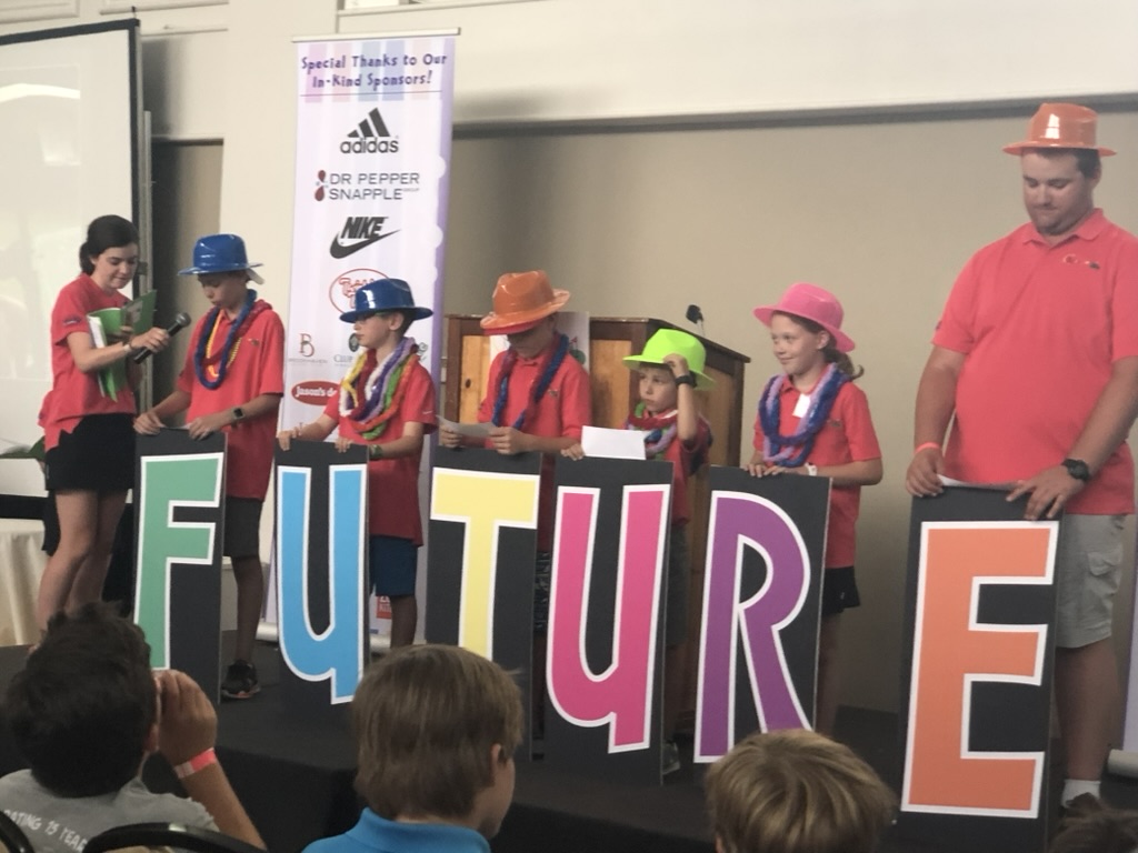 Andrew Hillman. KidSwing stage. Kids holding FUTURE letter signs.