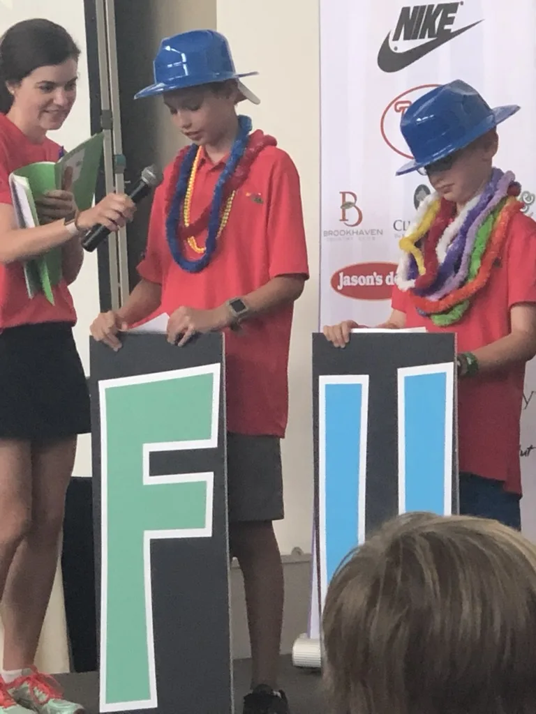 Andrew Hillman Dallas. KidSwing stage. Letter signs and in-kind sponsors.