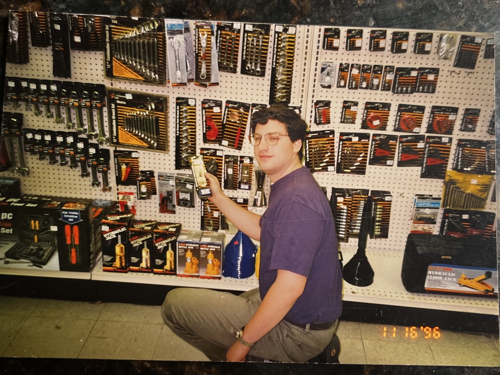 Andrew stocking shelves at the family auto parts stores. Date stamp November 16, 1996.