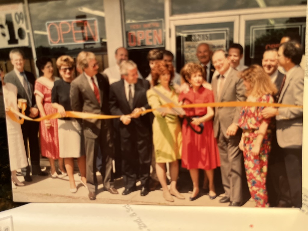 Ribbon-cutting at the family business Midway Auto Supply. Address 3215 is on the storefront.