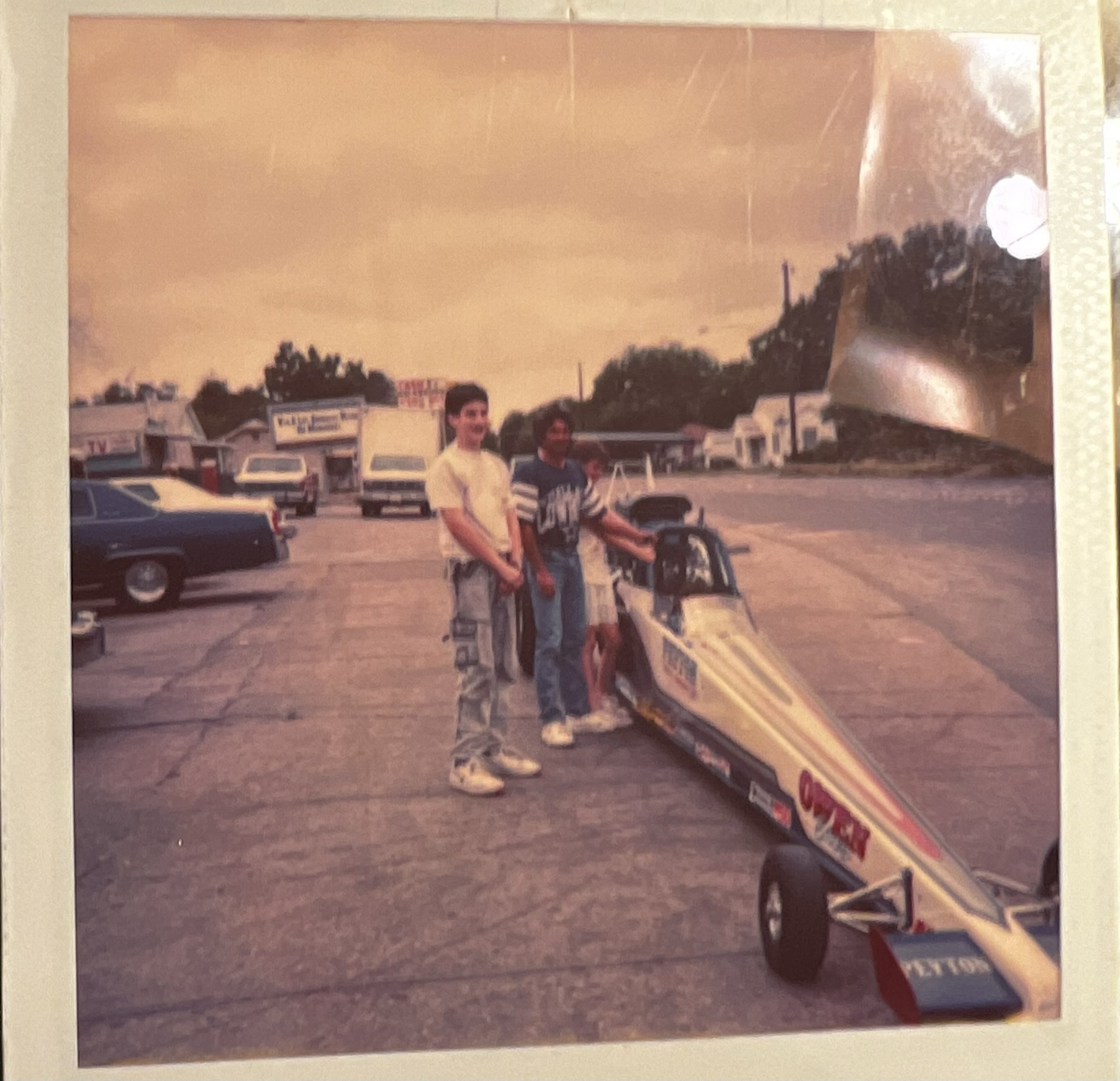 Andrew as a younger person with a race car, selling raffle tickets for the Oak Cliff Lions Club.