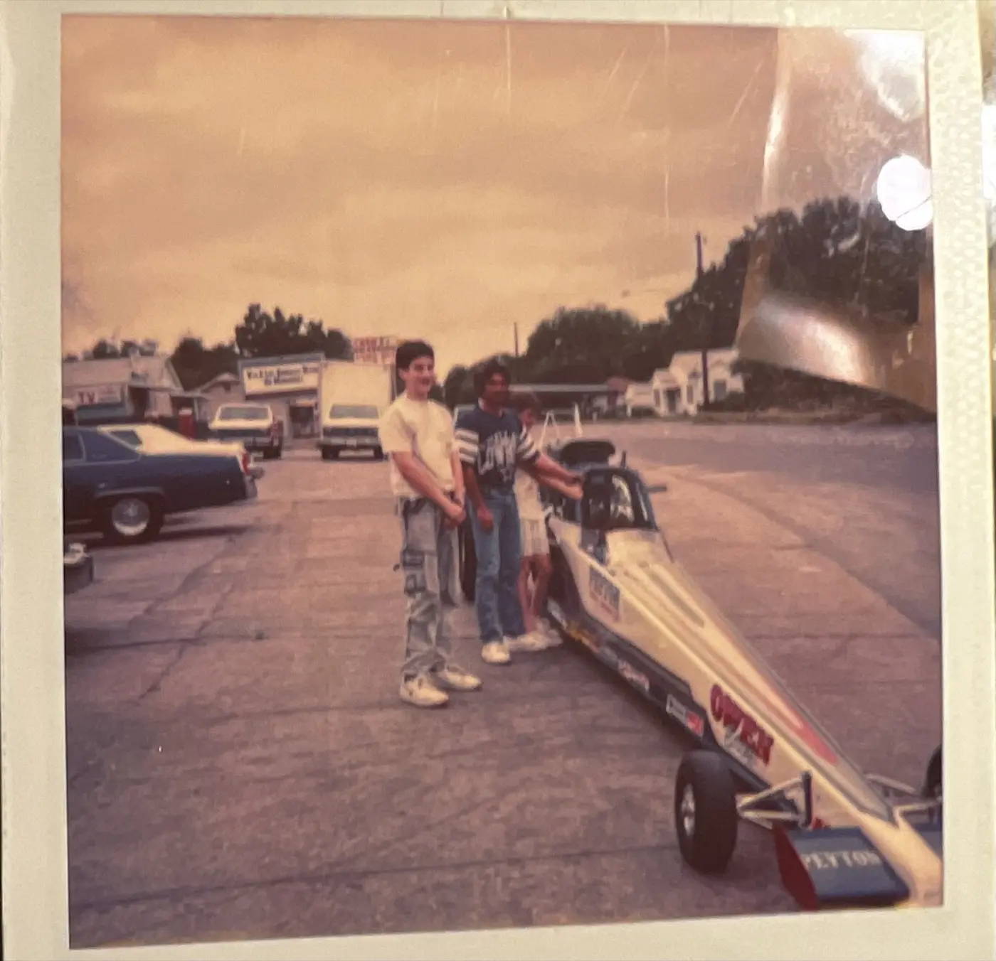 Andrew Hillman. Andrew as a younger person with a race car, selling raffle tickets for the Oak Cliff Lions Club.