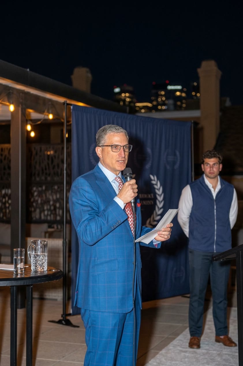 Andrew Hillman speaking at an evening event in Dallas