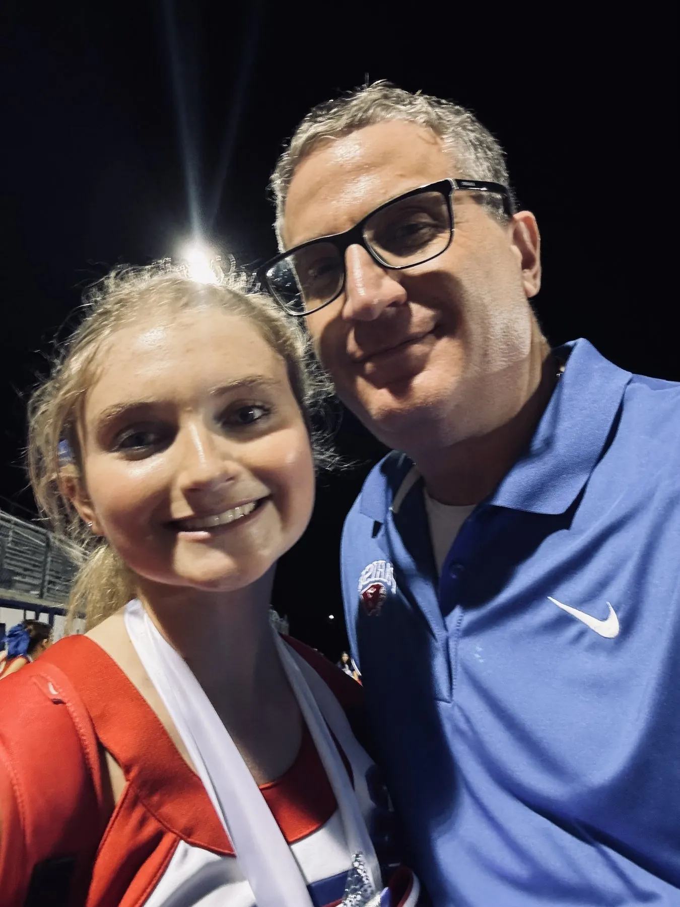 Andrew J. Hillman with a companion at a stadium at night. Night stadium selfie.