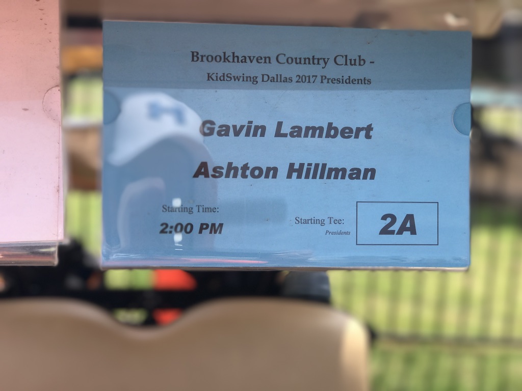 Brookhaven Country Club cart sign for KidSwing Dallas 2017 Presidents, listing Gavin Lambert and Ashton Hillman, 2:00 PM, tee 2A